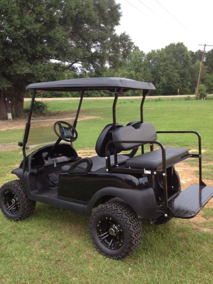 Black lifted golf cart with rear flip seat